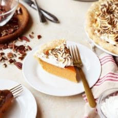 Slice of sweet potato pie with meringue on a small white plate.