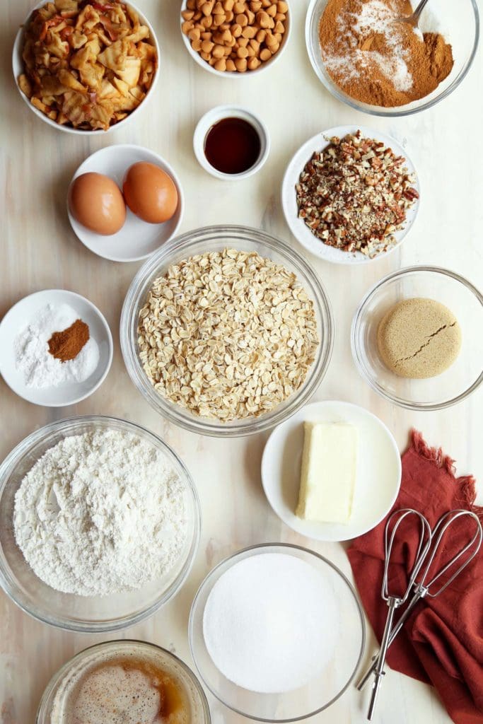 Ingredients for oatmeal cookies measure in small bowls.