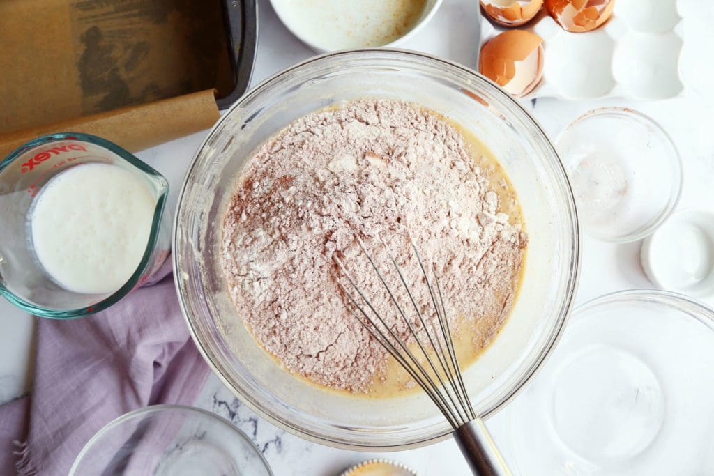 Dry ingredients added to bowl of sugar and flour.