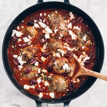 An easy chicken dinner recipe of tomatoes and feta in a cast iron skillet.