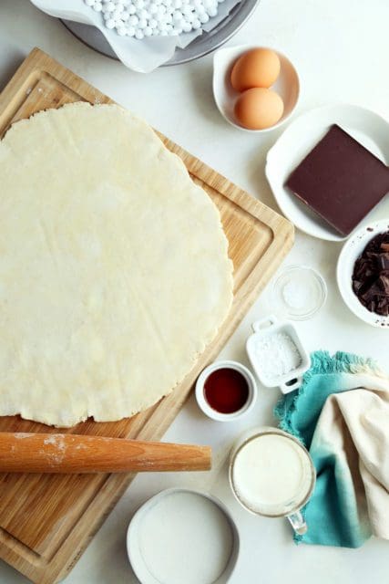 All-butter pie crust rolled out on wooden cutting board.