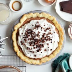 French silk pie topped with whipped cream and chocolate shavings.
