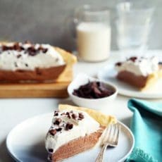 Slice of french silk pie on small blue plate.