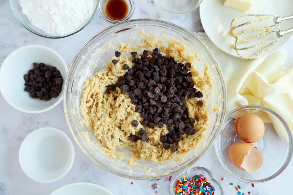 Chocolate chips added to cookie cake recipe batter.