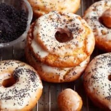 Two glazed doughnuts piled together.