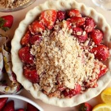 Strawberry pie filling inside of unbaked crust with crumble top.