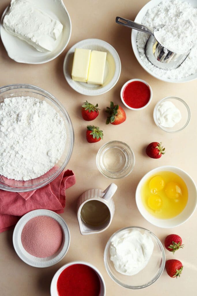 Ingredients for strawberry cake in small bowls for baking.
