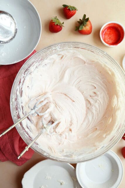 whipped cream cheese frosting in large bowl with beaters.