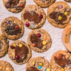 Baked Taylor Swift cookies on parchment paper.