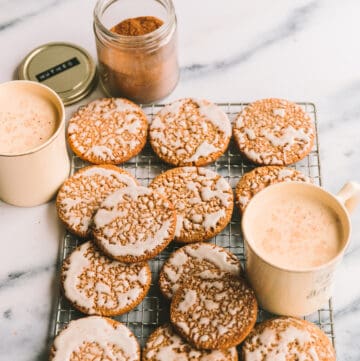 Iced Oatmeal Cookies layered on a cooling rack.