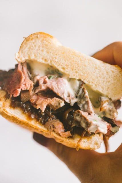 close up of a French dip sandwich cut in half