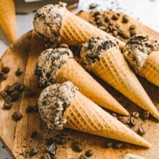 ice cream cones on a wooden board surrounded by coffee beans
