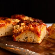 a straightforward angle of a slice of doughy, bready focaccia pizza